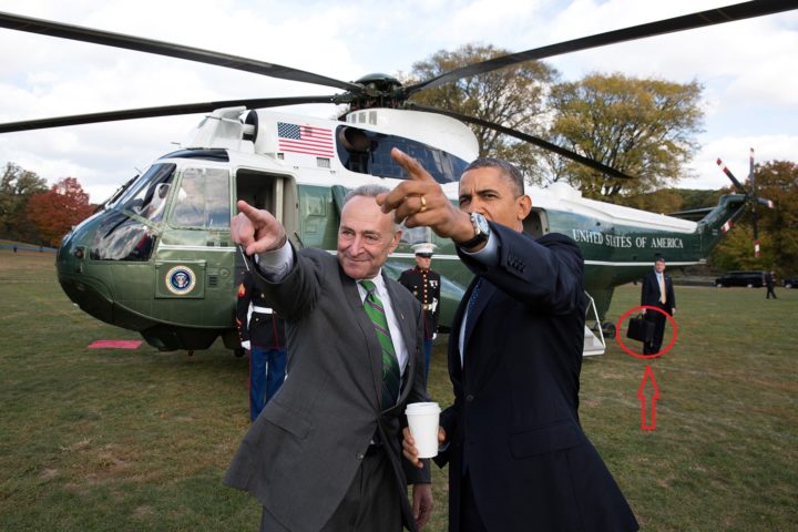 Barack Obama accompanied by the nuclear briefcase