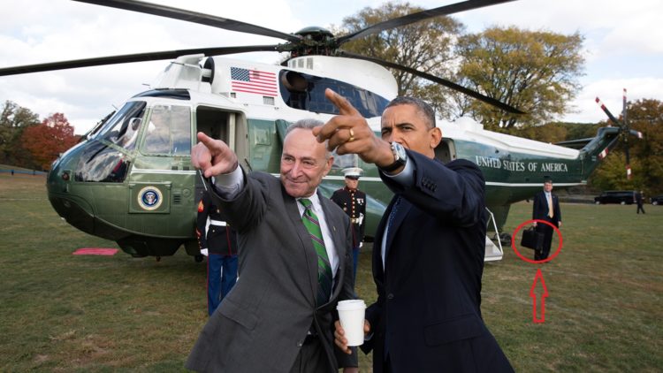 Barack Obama accompanied by the nuclear briefcase