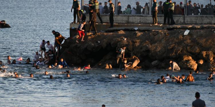 Migrants swimming around the Tarajal spur