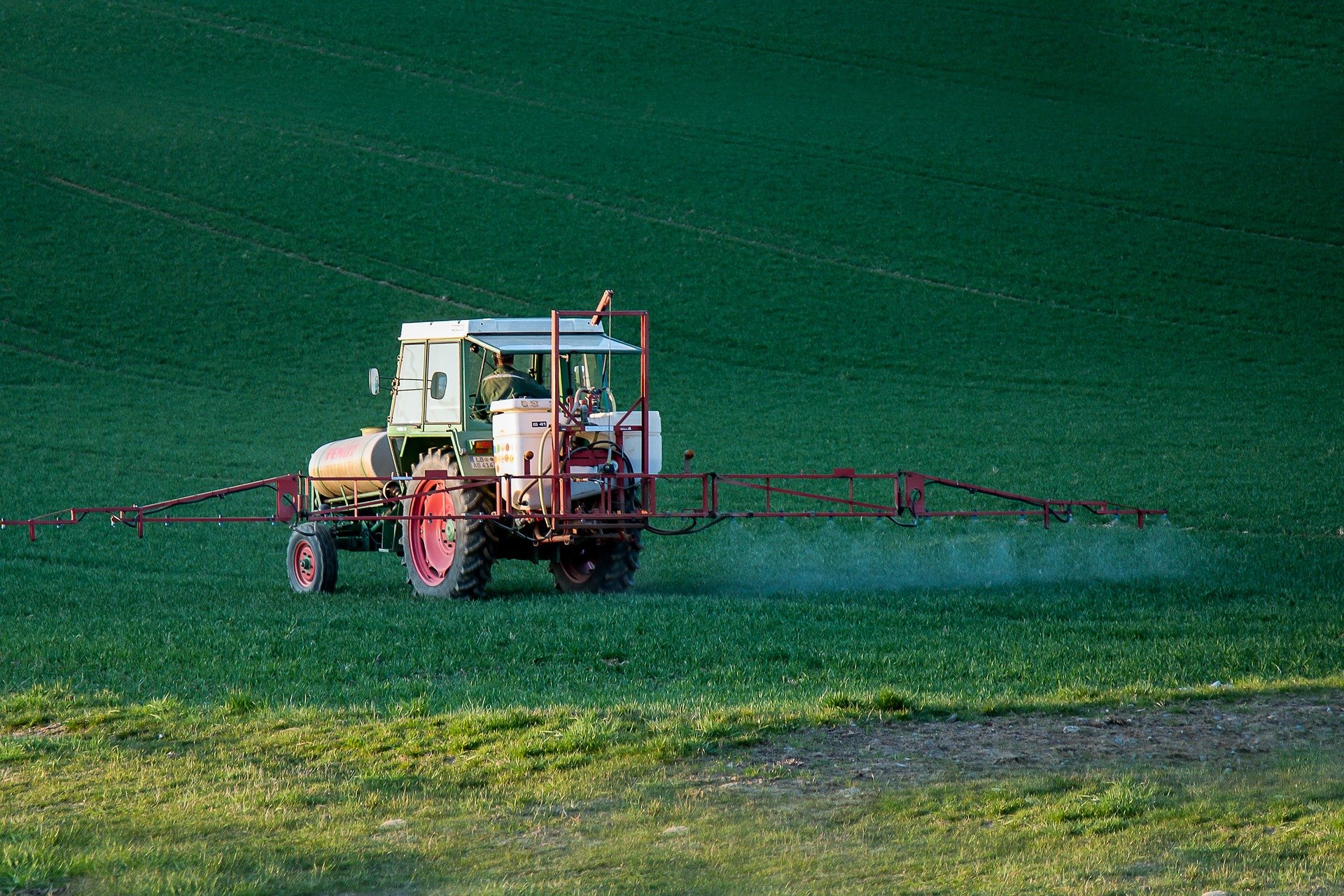 Traktor, der Pestizid auf einem Acker versprüht