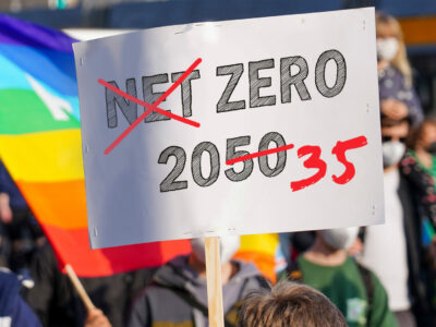 Photo a street protest sign saying "Net Zero 2050" with the word "Net" crossed over and 2050 changed to 2035.